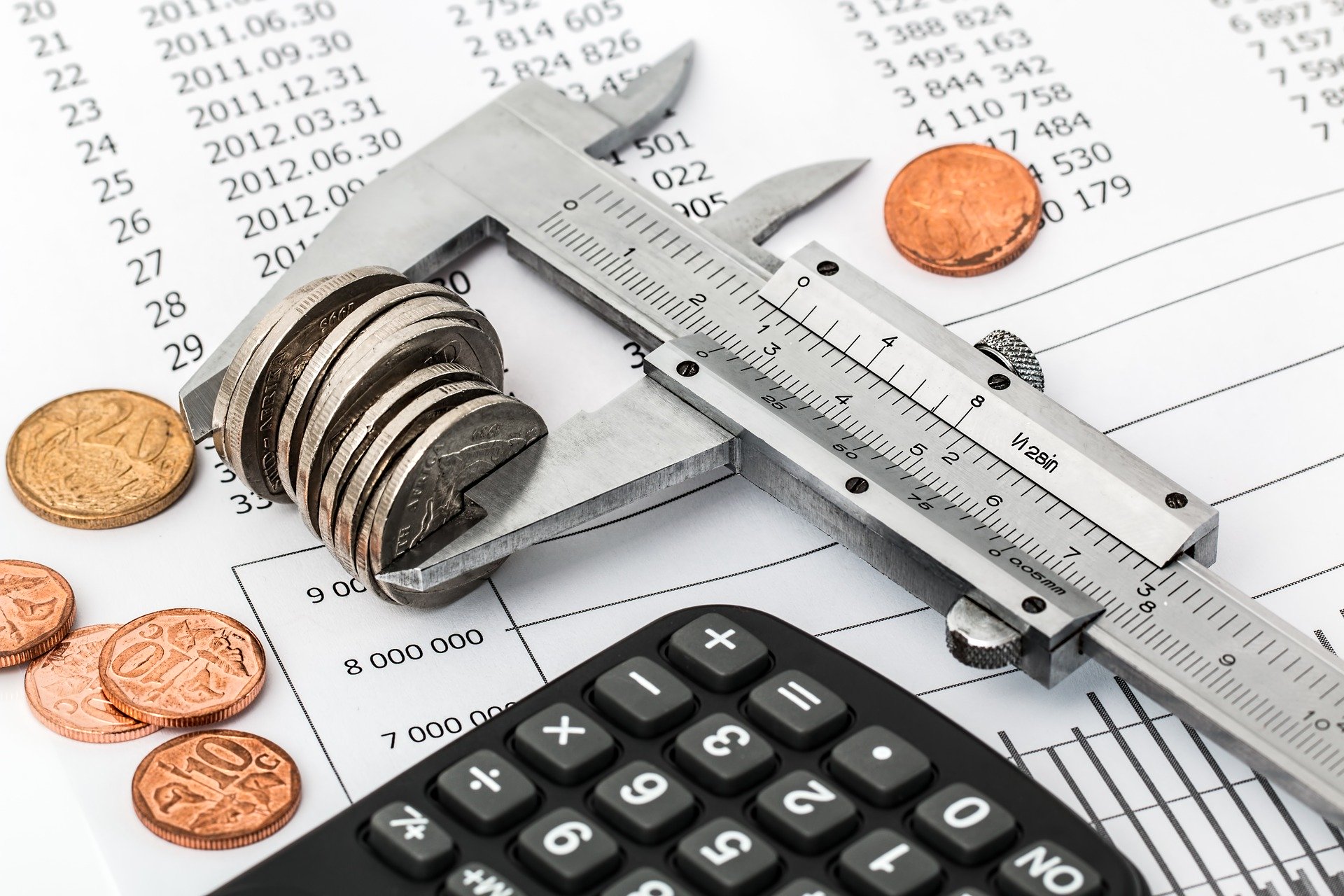 calculator and coins with ruler