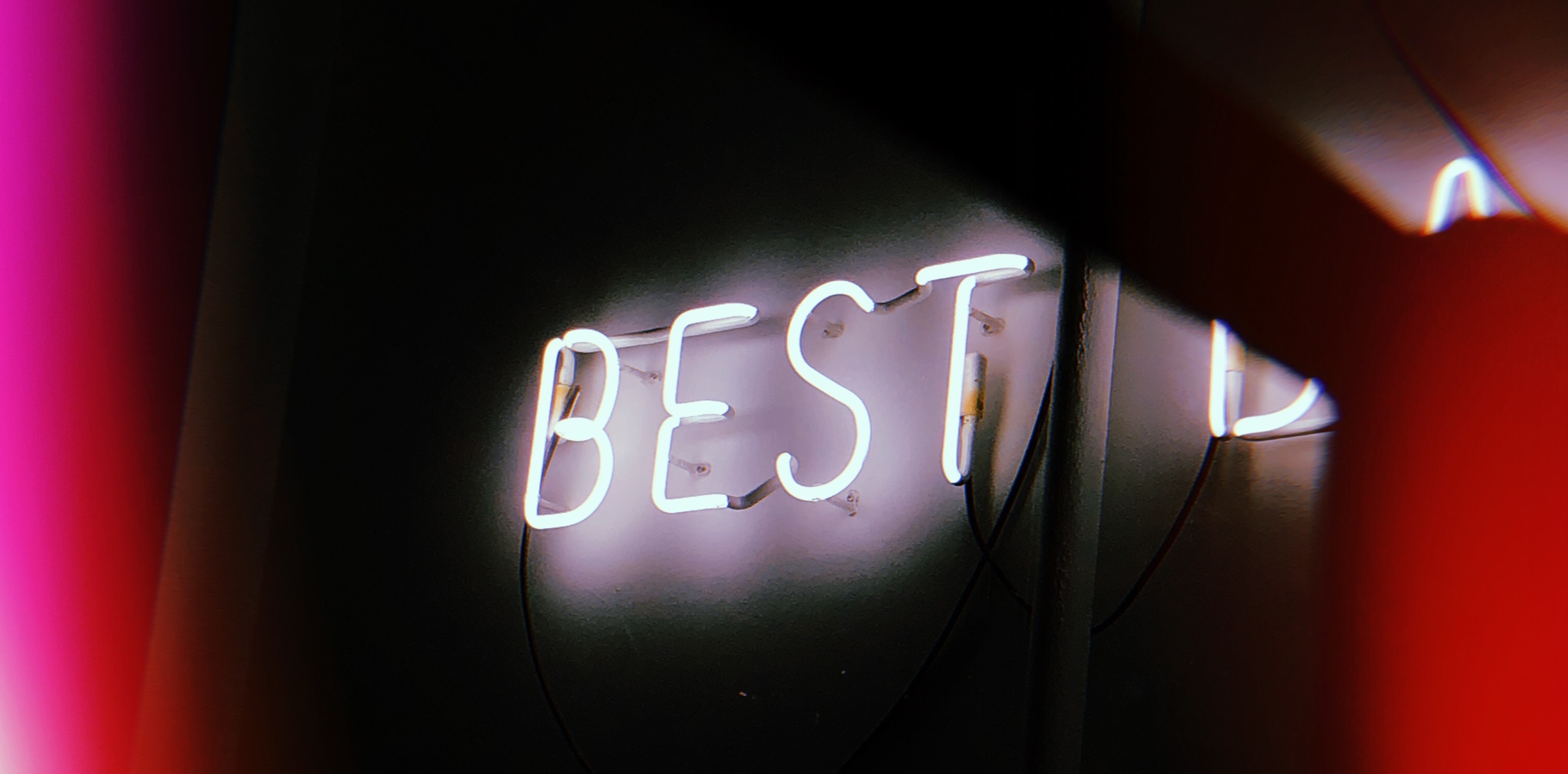 photo of a neon sign saying 'best'