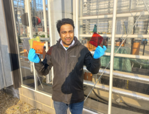 Sagar Jain holding samples of the photovoltaic films